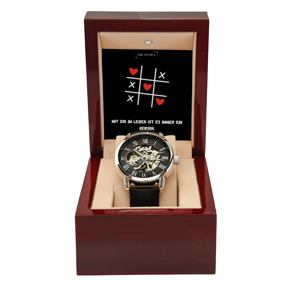 Timeless Elegance Skeleton Watch mit schwarzem Echtleder-Armband und offenem Skelett-Design, präsentiert als stilvolles Geschenk für Männer – ein Liebesbeweis von ihr an ihn.