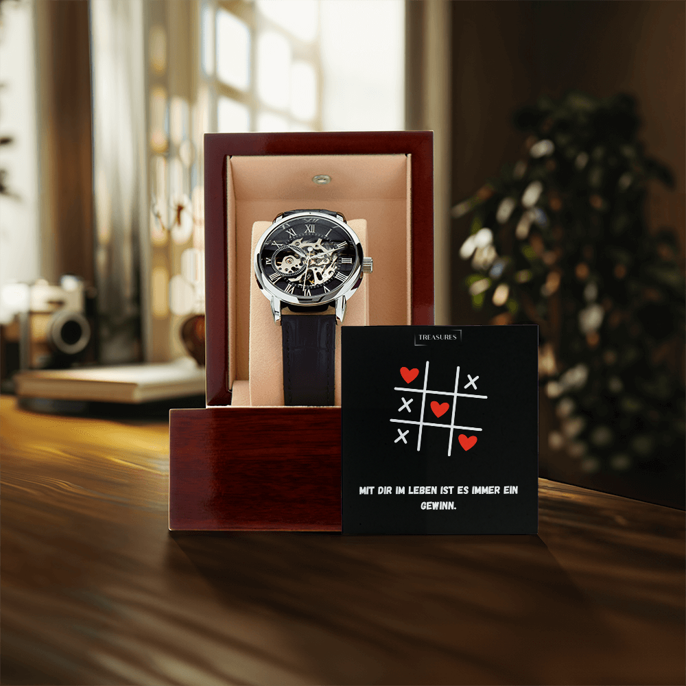 Timeless Elegance Skeleton Watch mit schwarzem Echtleder-Armband und offenem Skelett-Design, präsentiert als stilvolles Geschenk für Männer – ein Liebesbeweis von ihr an ihn.