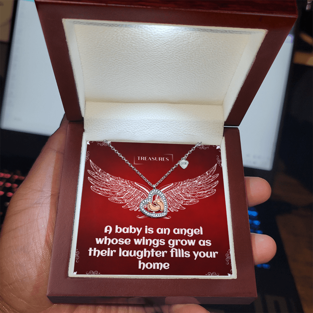 Heart-shaped necklace with sparkling cubic zirconia and delicate rose gold baby feet, symbolizing love, family, and new beginnings.
