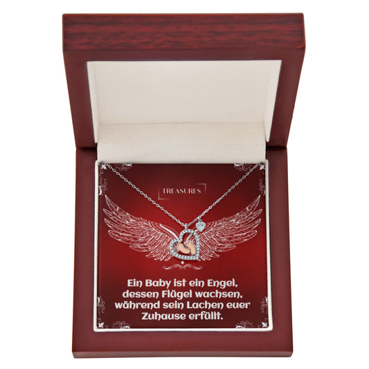 Herzförmige Halskette mit funkelnden Zirkonia und zarten roségoldenen Babyfüßchen – ein Symbol für Liebe, Familie und Neuanfänge.