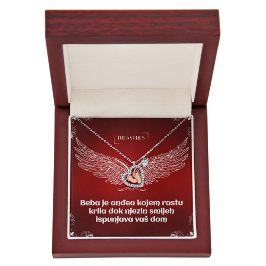 Ogrlica u obliku srca s blistavim kubičnim cirkonima i nježnim bebinim stopalima u ružičastom zlatu – simbol ljubavi, obitelji i novih početaka.
